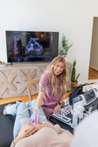Mom during at-home diagnostic pregnancy ultrasounds in Nashville with Kicks & Flutters.