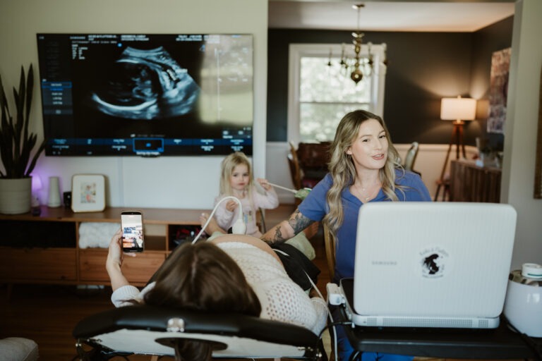 at home ultrasound session in Nashville with family present and sonographer performing scan